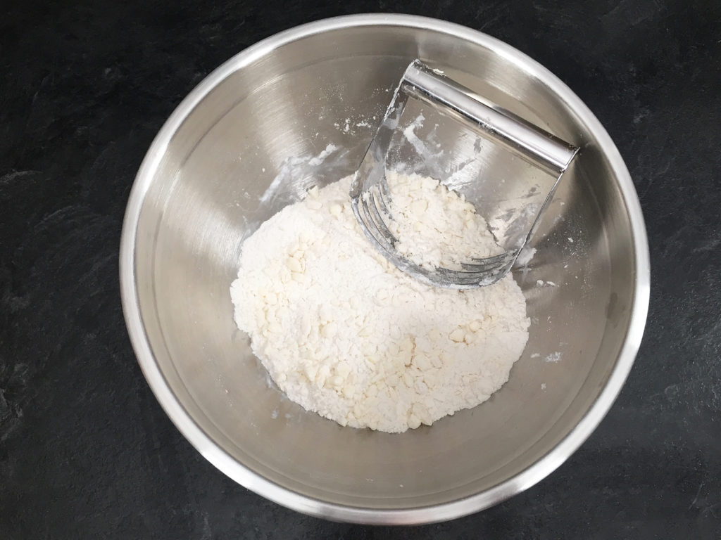 cutting butter into flour with pastry blender
