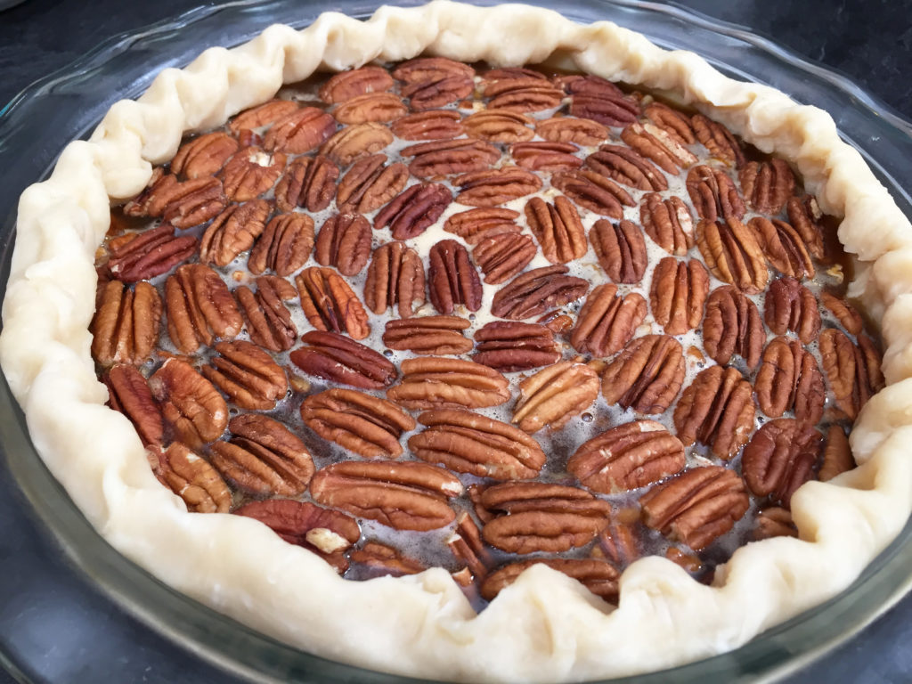 pecan pie with crimped edge ready for oven