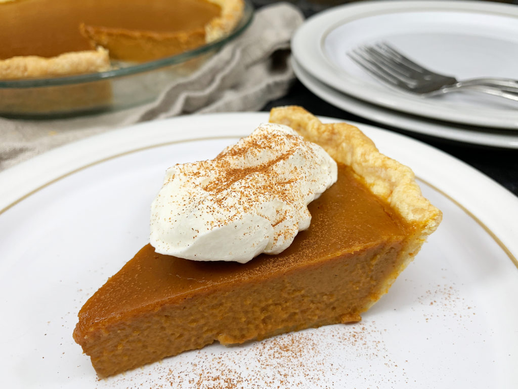 slice of pumpkin pie with whipped cream