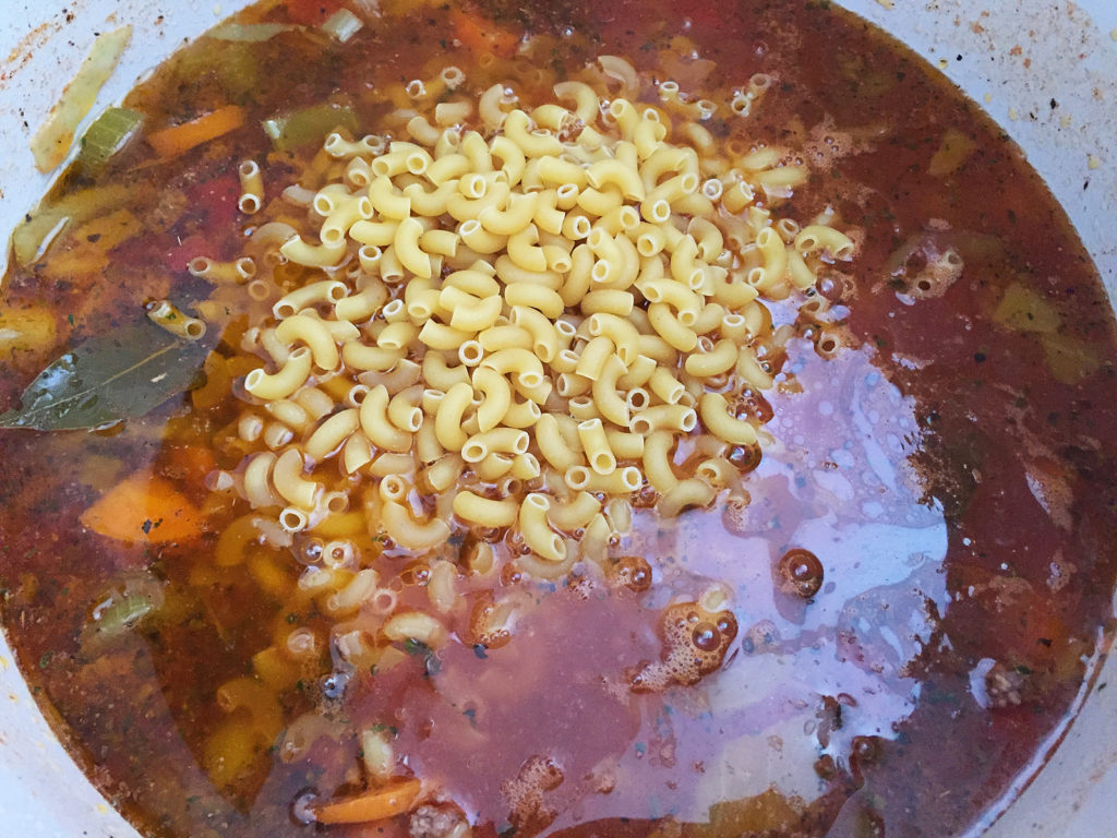 adding pasta to soup