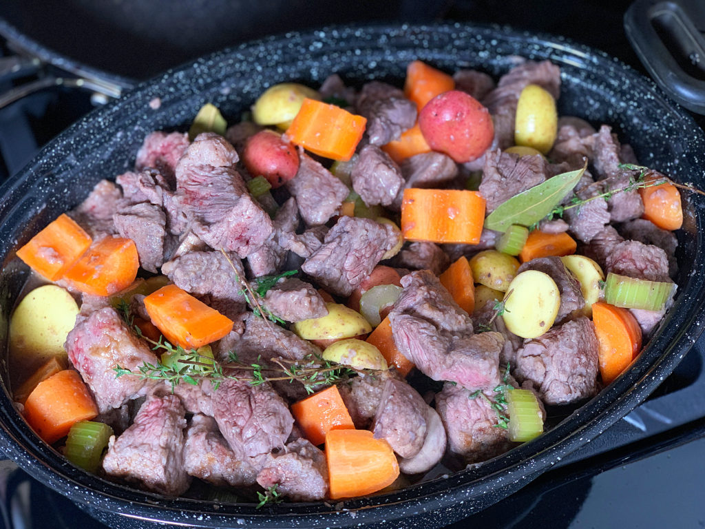 stew ingredients in pot ready for oven