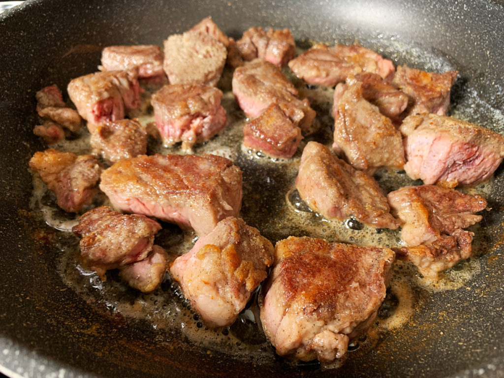 beef cubes browning in frying pan