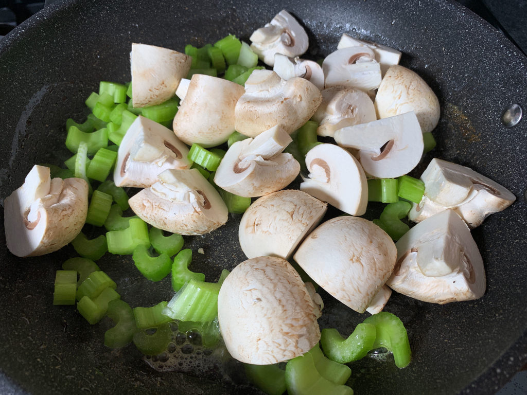 mushrooms and celery in frying pan