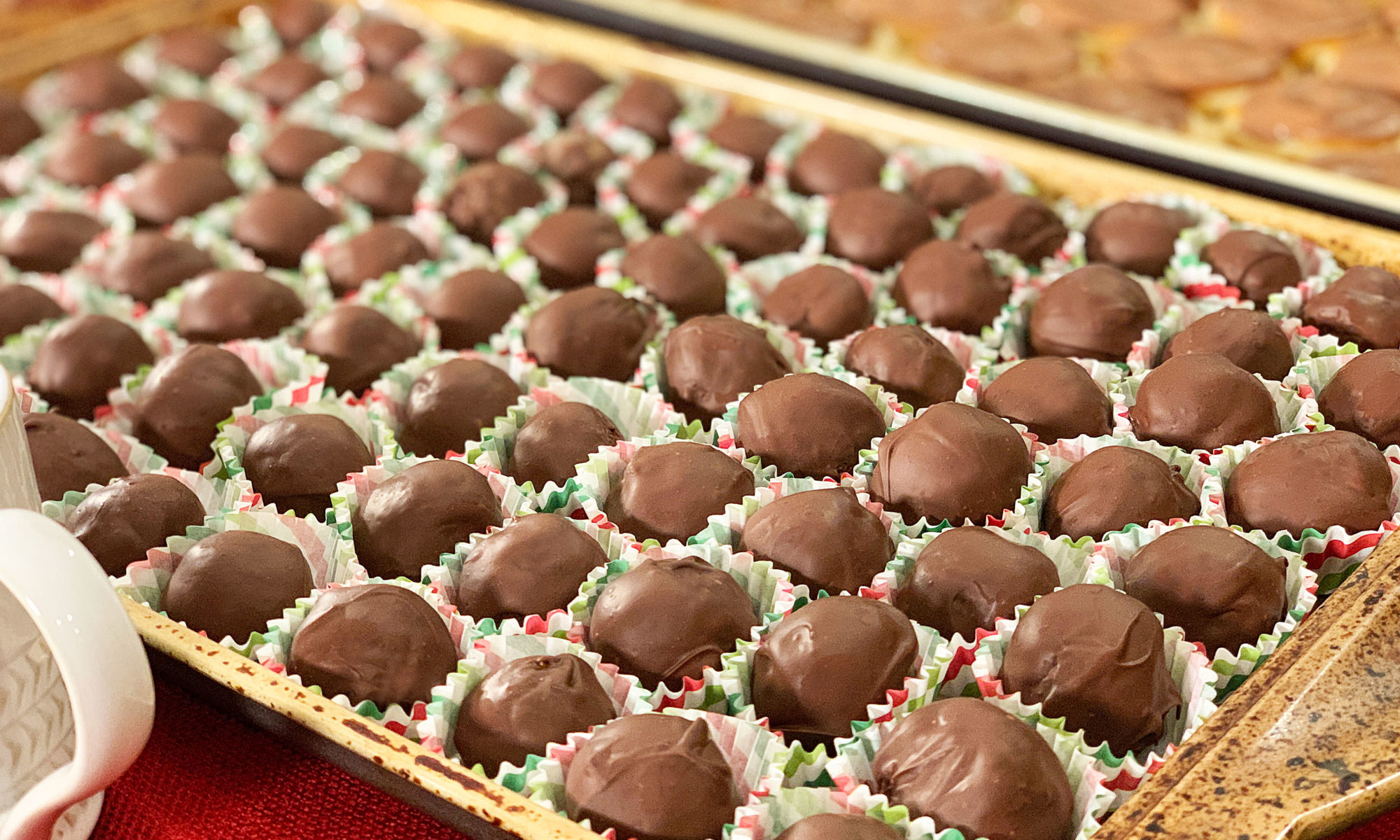 tray of chocolate covered bourbon balls in little paper cups