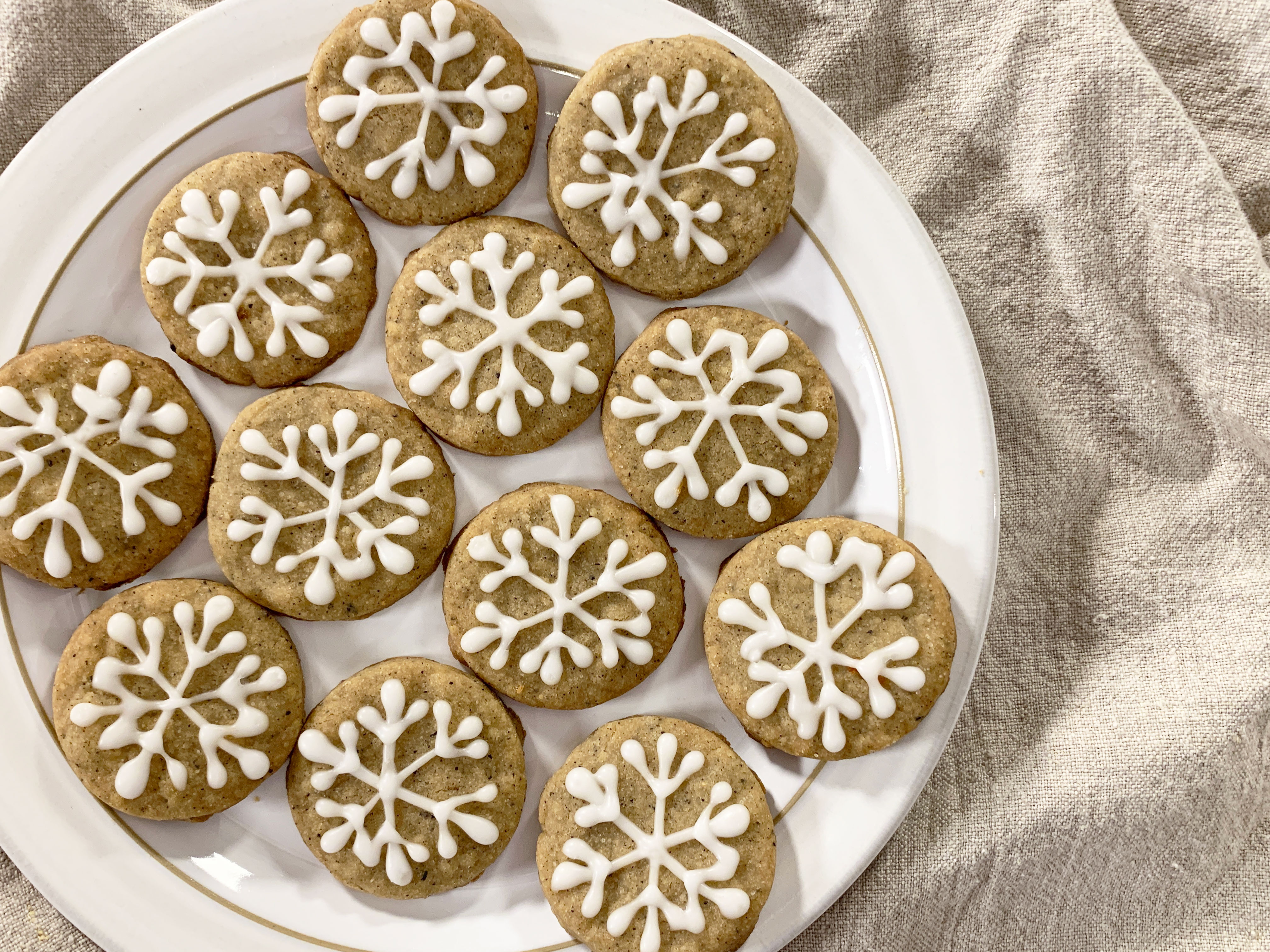 plate of iced chai snowflake cookies