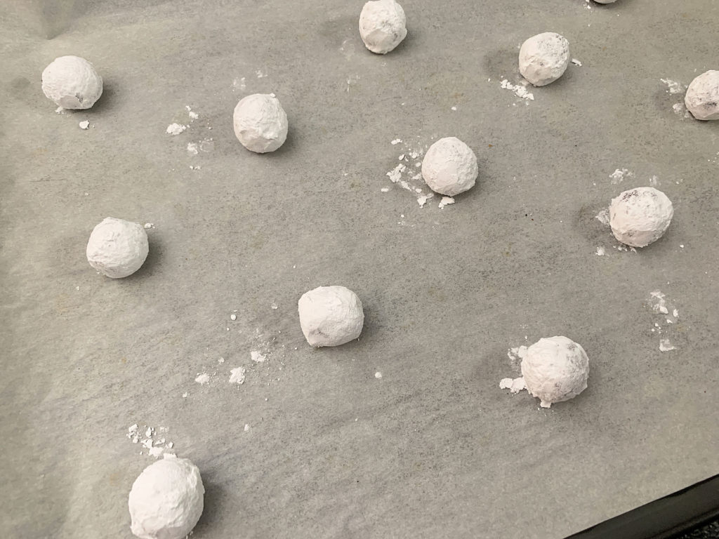 cookie dough balls on a cookie sheet