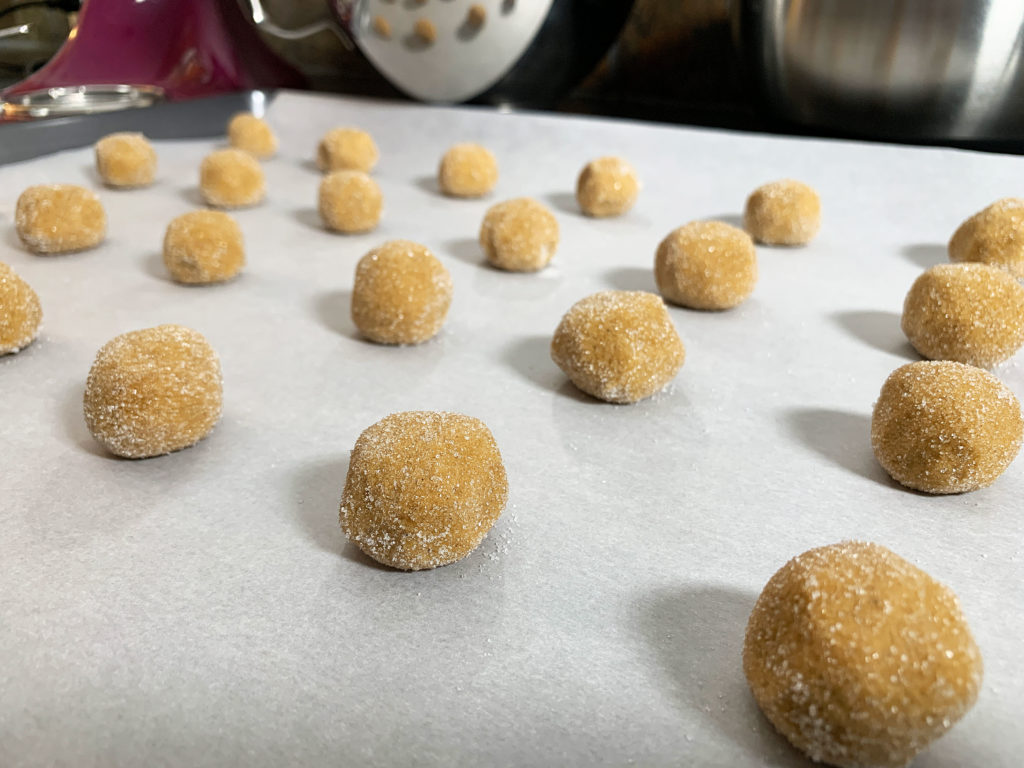 a tray of unbaked cookie dough balls