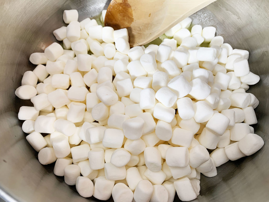 adding mini marshmallows to saucepan