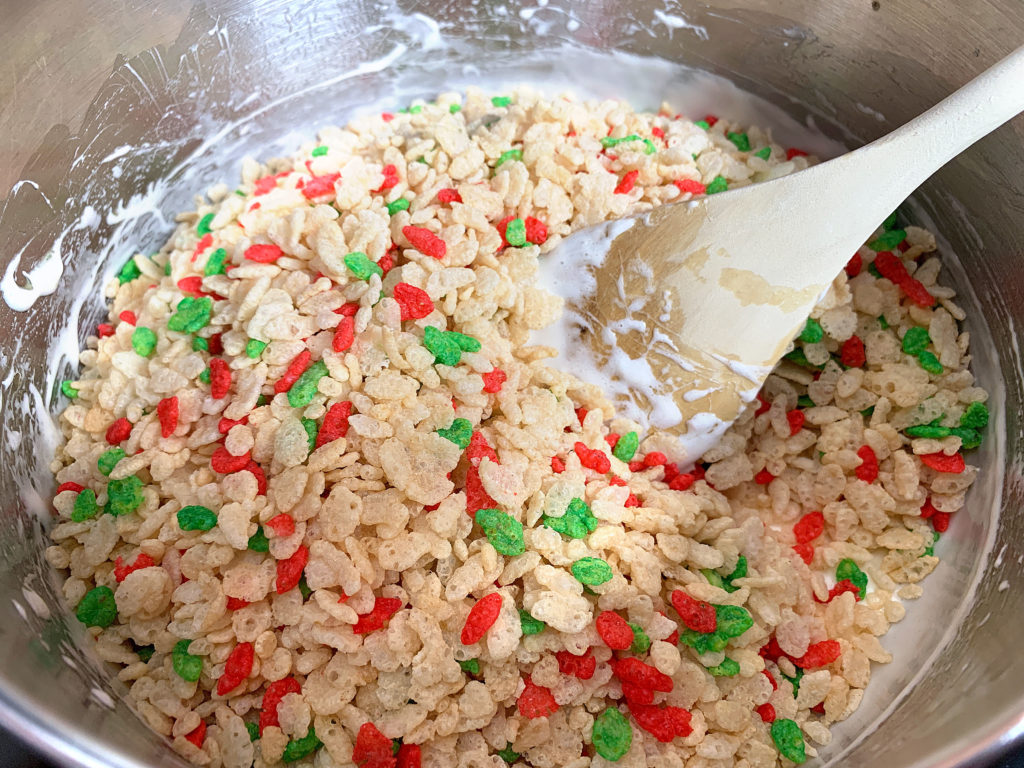 adding rice krispies to the saucepan with the marshmallows