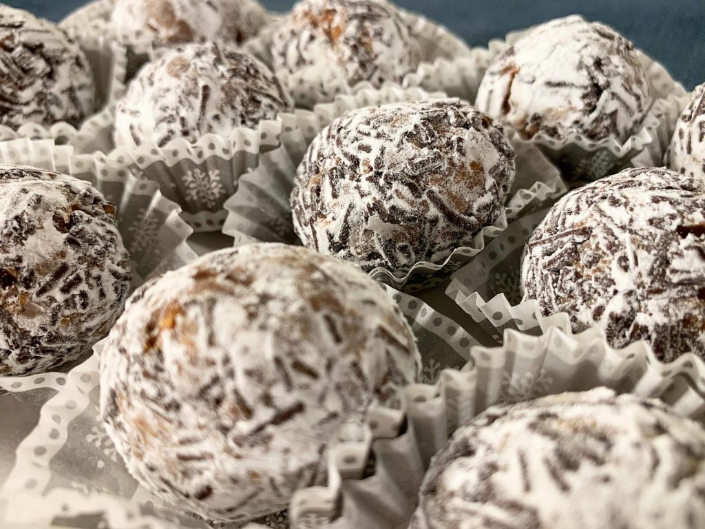 close up of rum balls in snowflake themed mini muffin cups