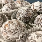 close up of rum balls in snowflake themed mini muffin cups