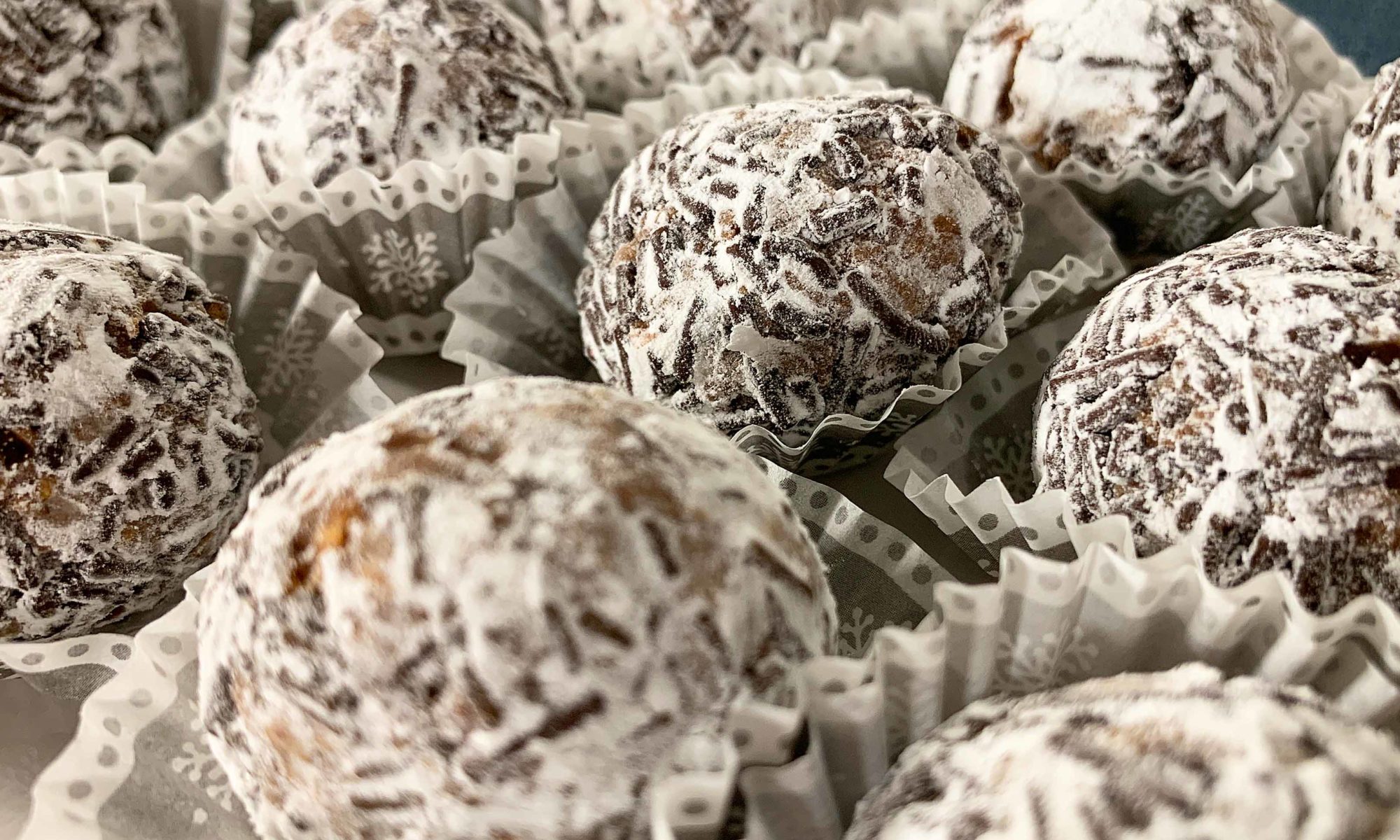close up of rum balls in snowflake themed mini muffin cups