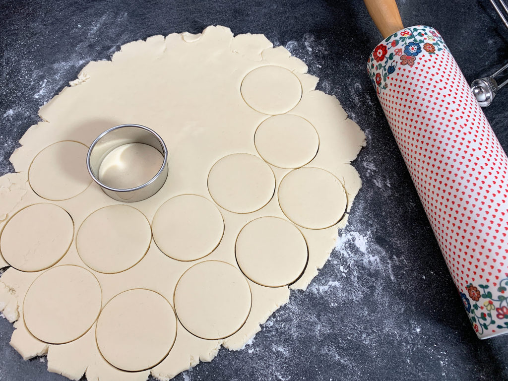 cutting the dough with cookie cutters
