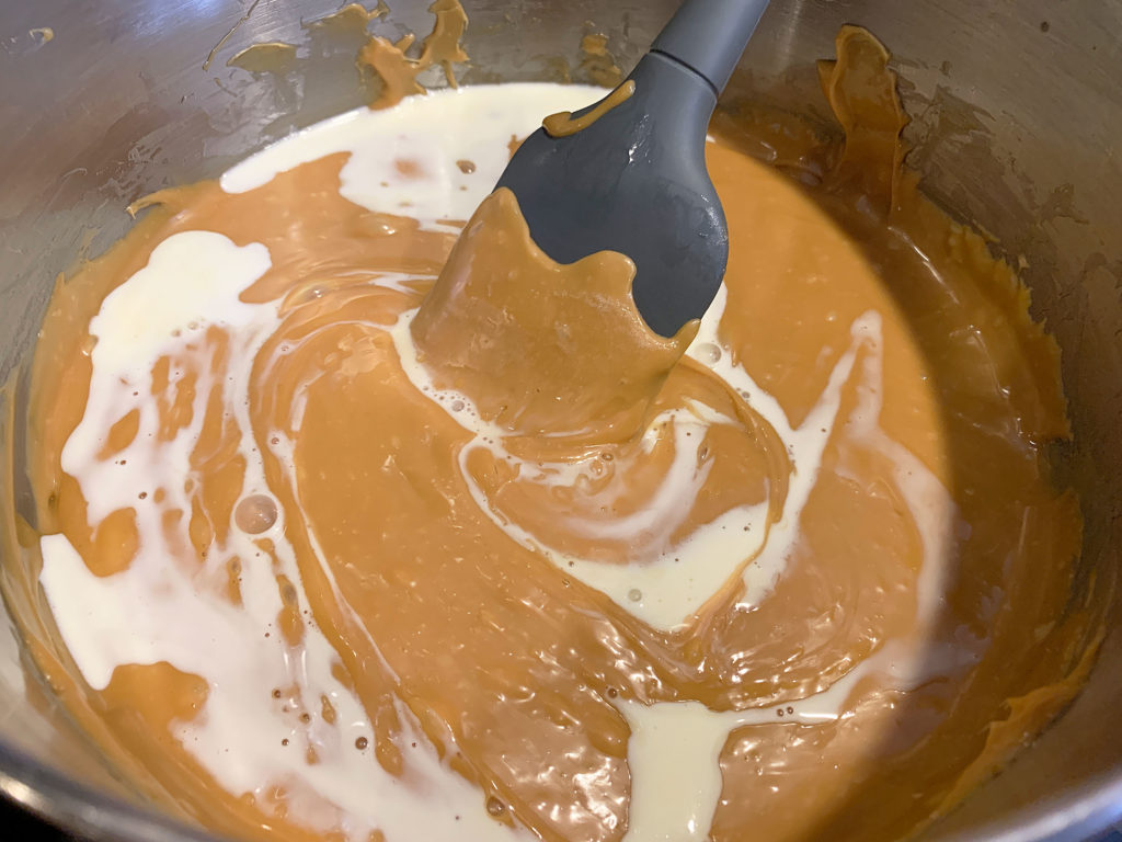 stirring cream into the melted caramels