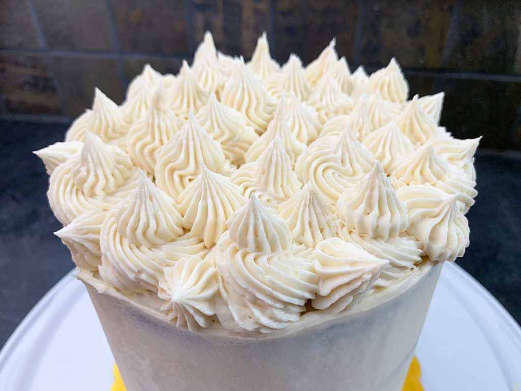 close up of cake with buttercream piped on top
