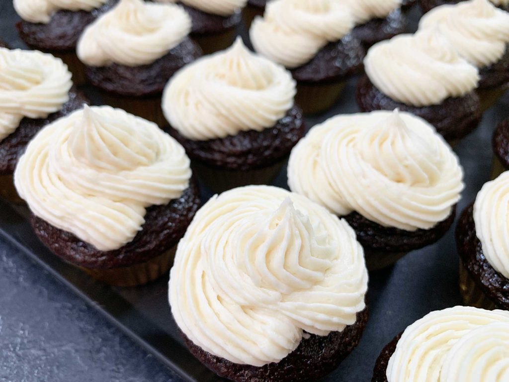 close up of chocolate cupcakes frosted with baileys buttercream