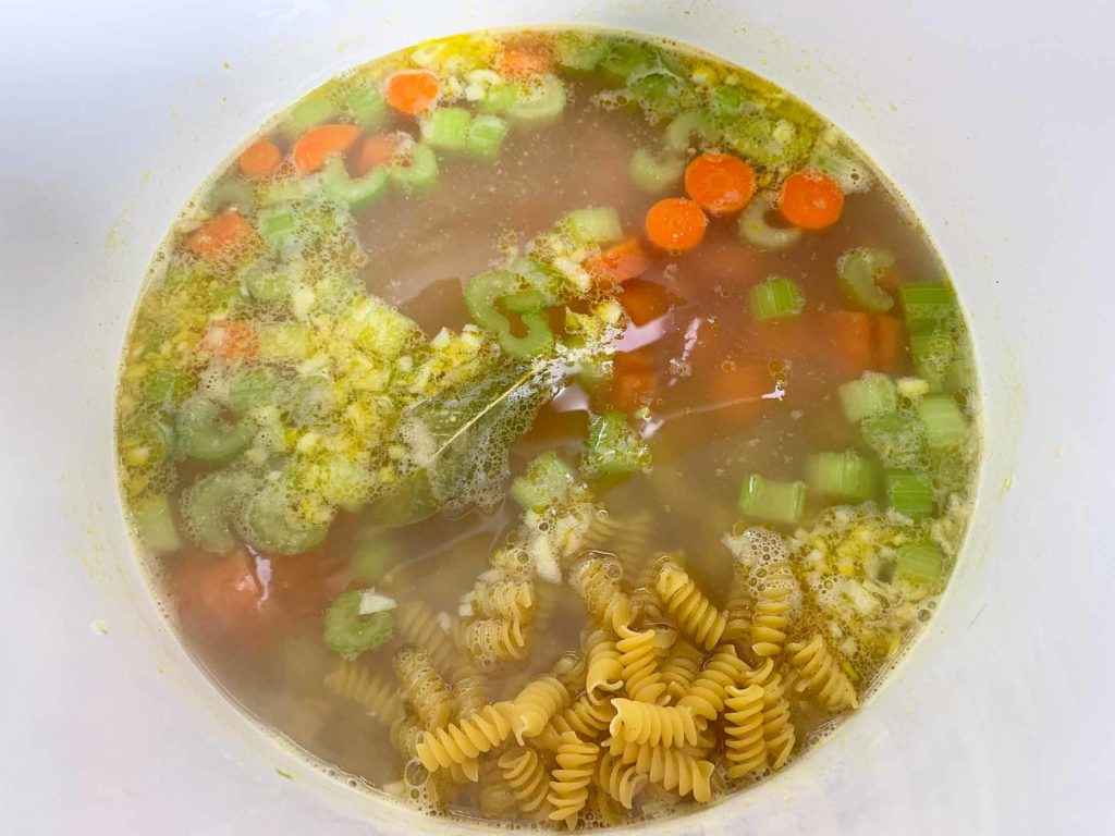 adding noodles to the chicken noodle soup