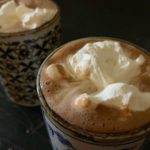 hot chocolate in mugs, topped with whipped cream
