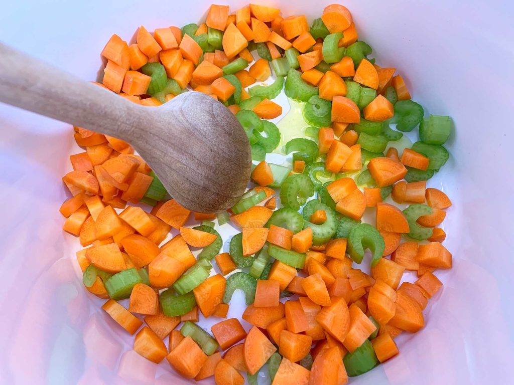 cooking the carrots and celery in a large pot