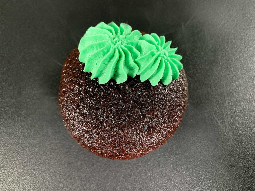 buttercream on cupcake piped like a round cactus