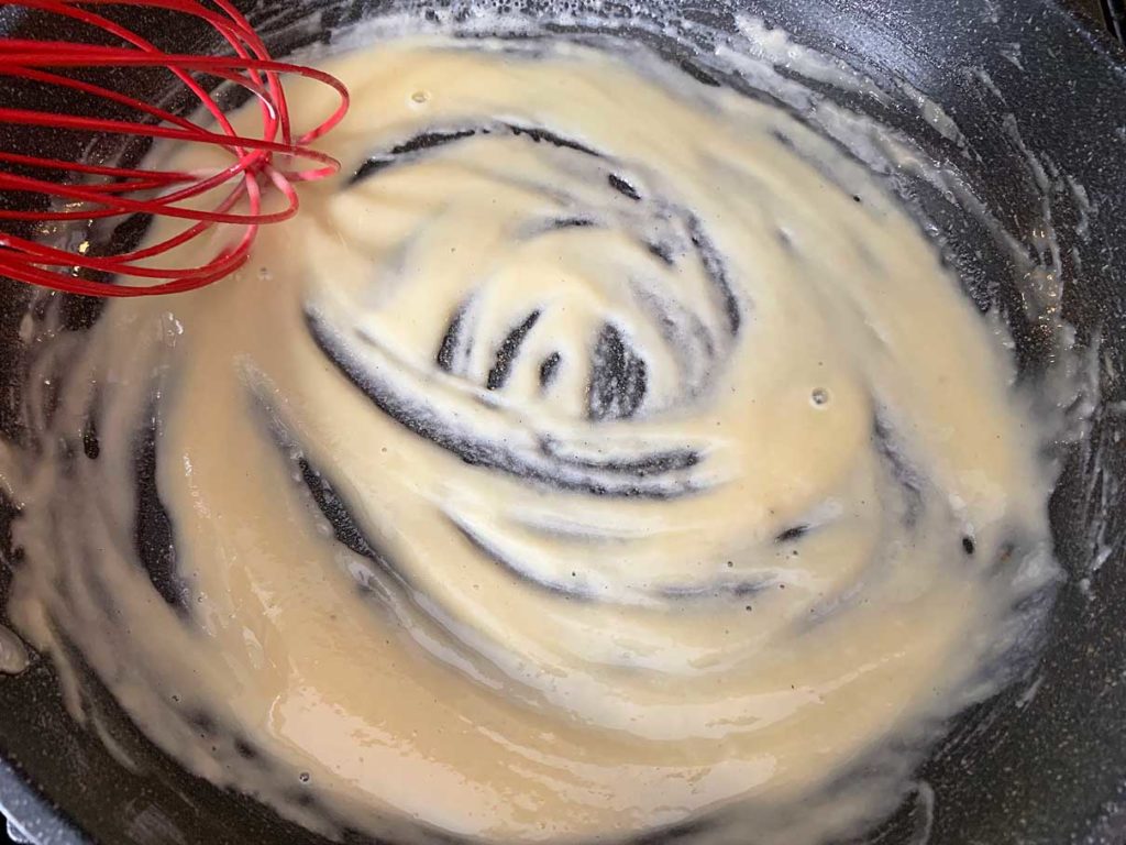 mixing the flour into the butter to make a thick paste