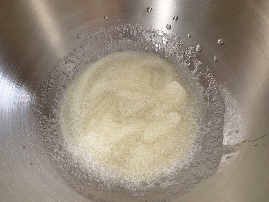 Gelatin powder, mixed with water in bowl