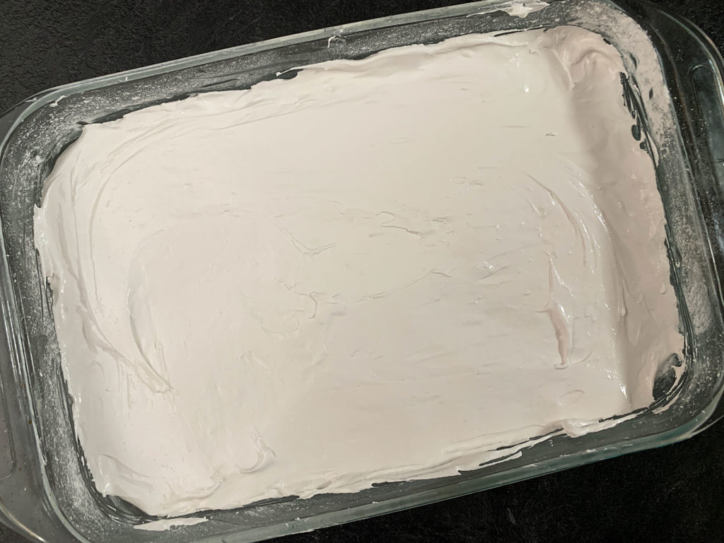 Marshmallow mixture spread evenly into a 9x13 pan