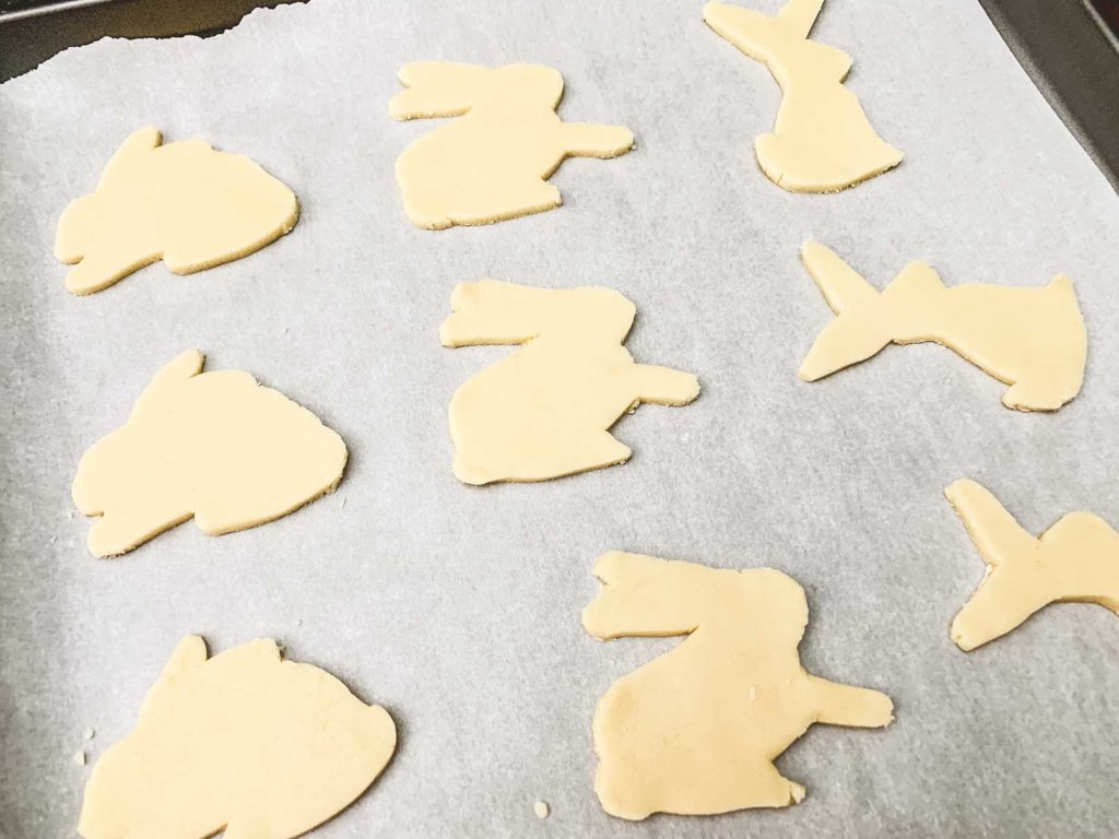 sugar cookie dough cut outs on baking tray