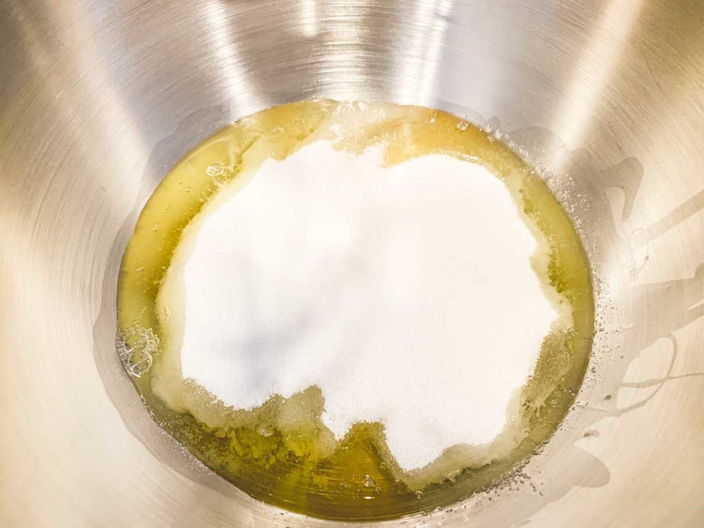 Sugar and eggs in the bowl of a stand mixer