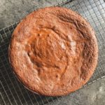 overhead shot of flourless chocolate cake on a cooling rack
