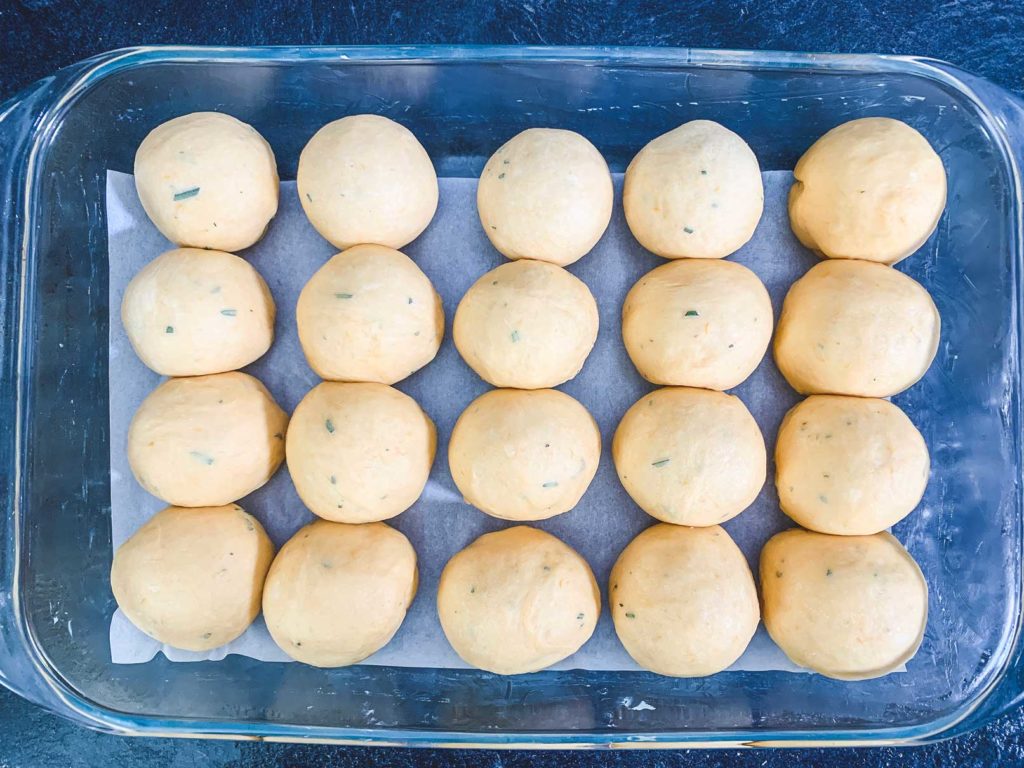 dough balls placed in greased baking dish
