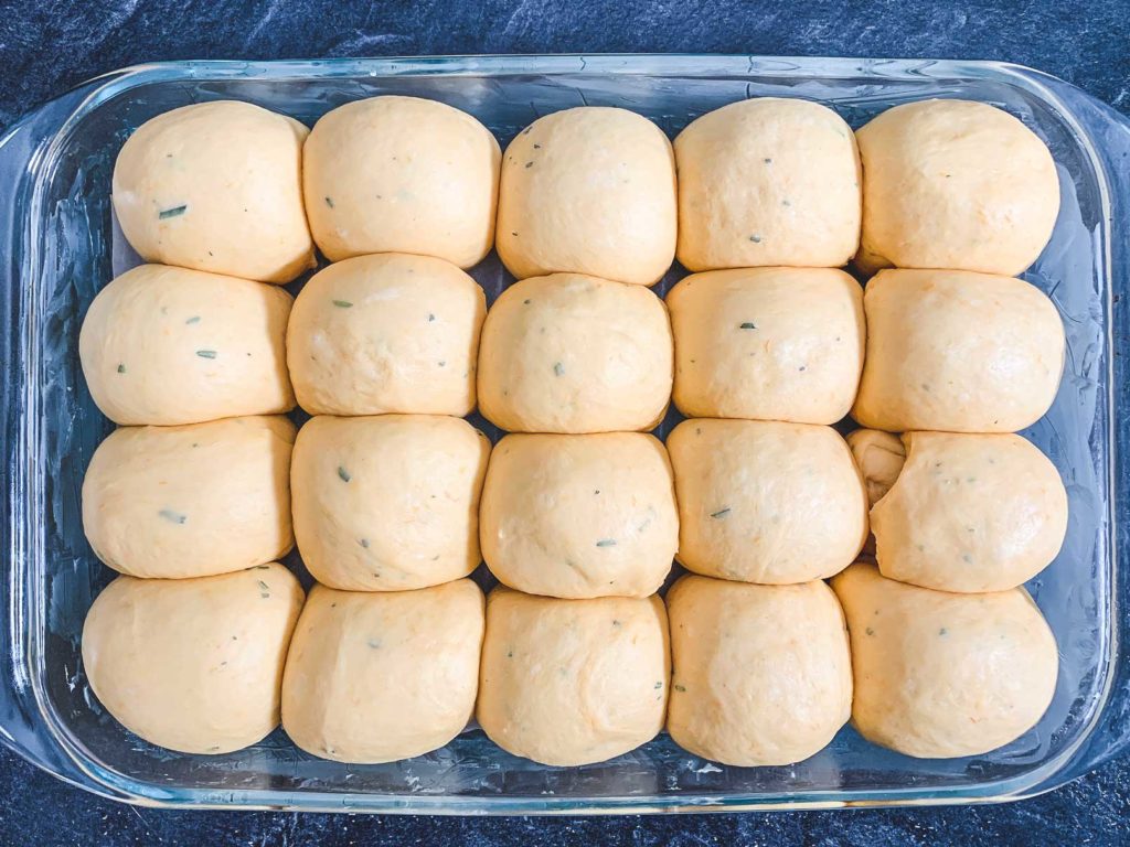 dough balls in baking dish after being left to rise