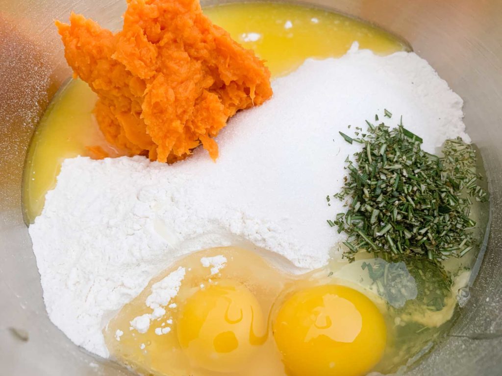 flour, sugar, salt, sweet potato, rosemary and egg in mixing bowl