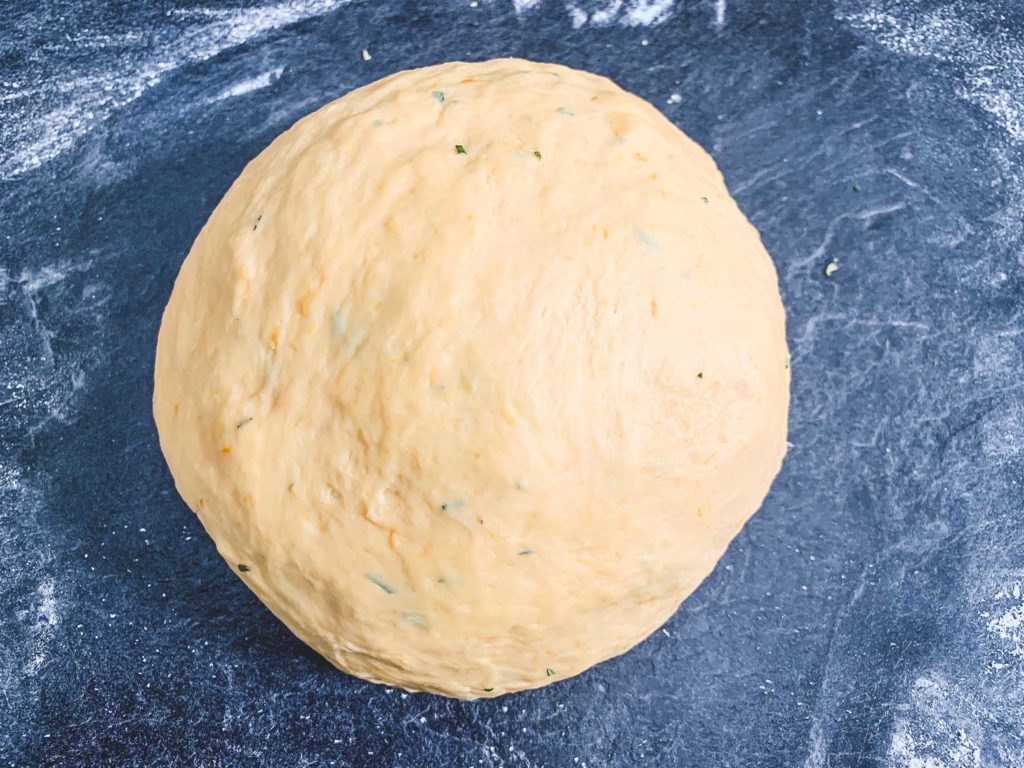 ball of kneaded dough on floured surface