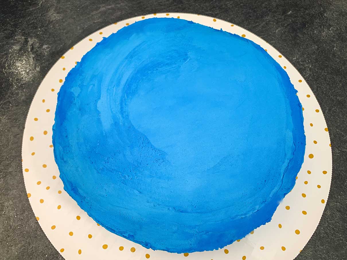 9 inch round cake covered in blue frosting