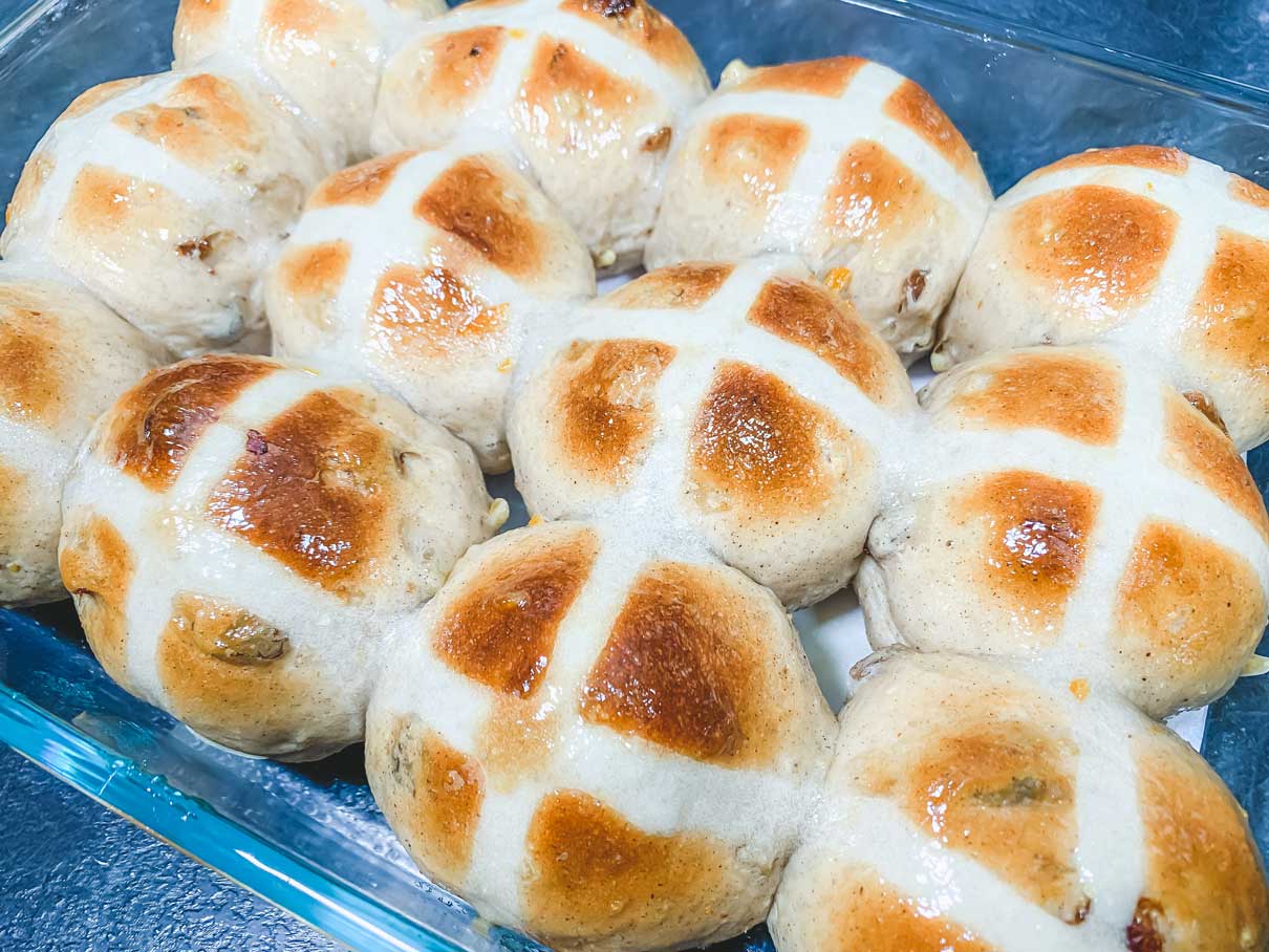 tops of hot cross buns brushed with glaze