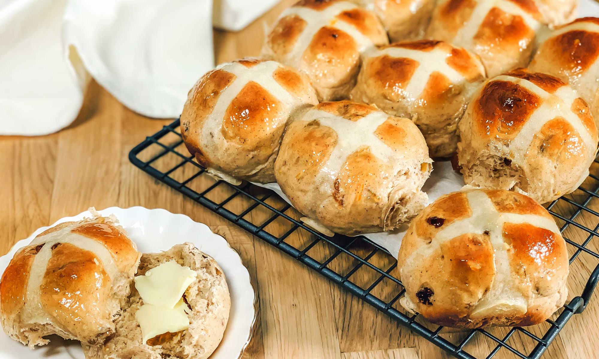 hot cross buns cooling on a wire rack