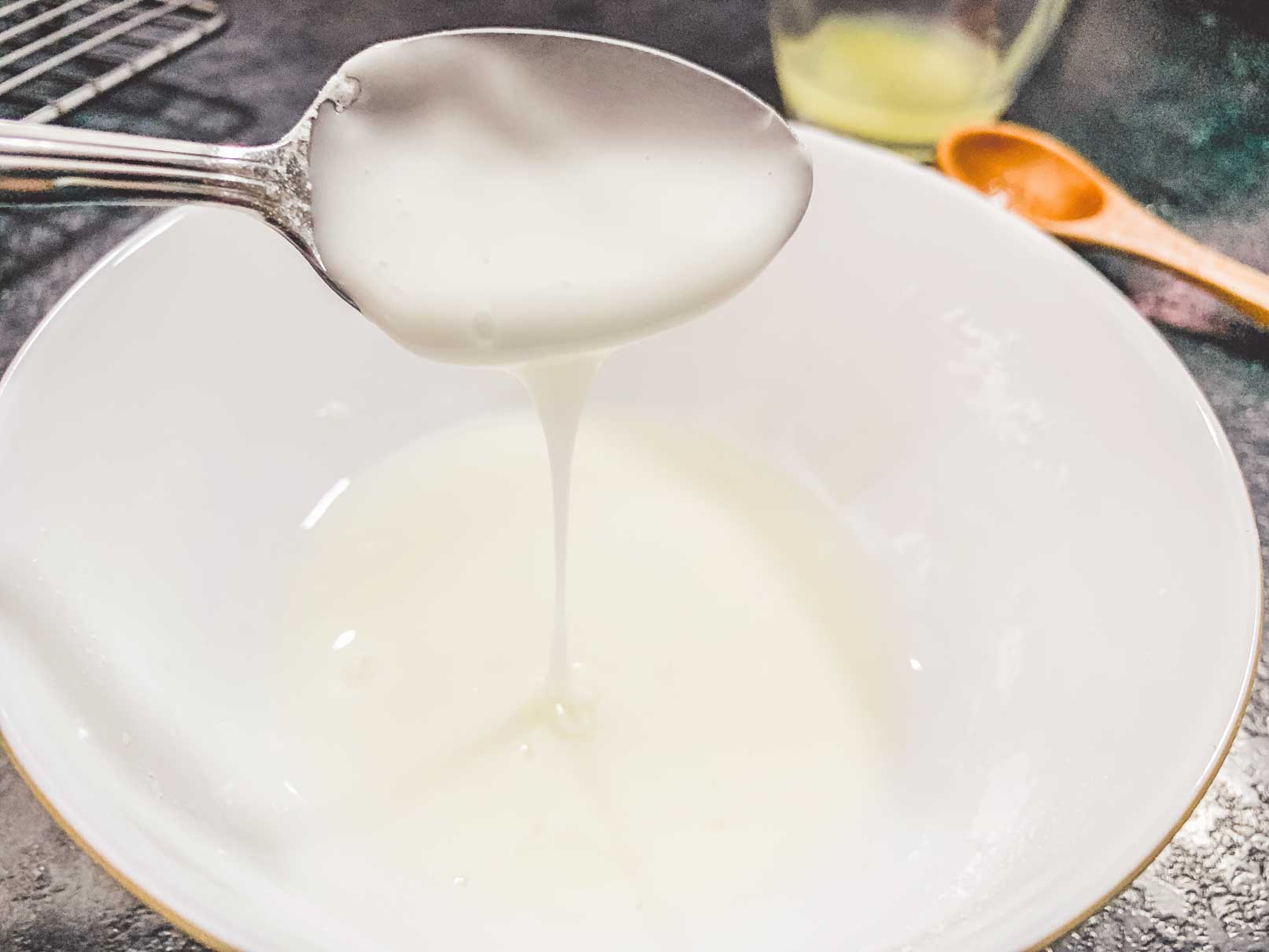 mixing icing sugar and lemon juice together in a bowl