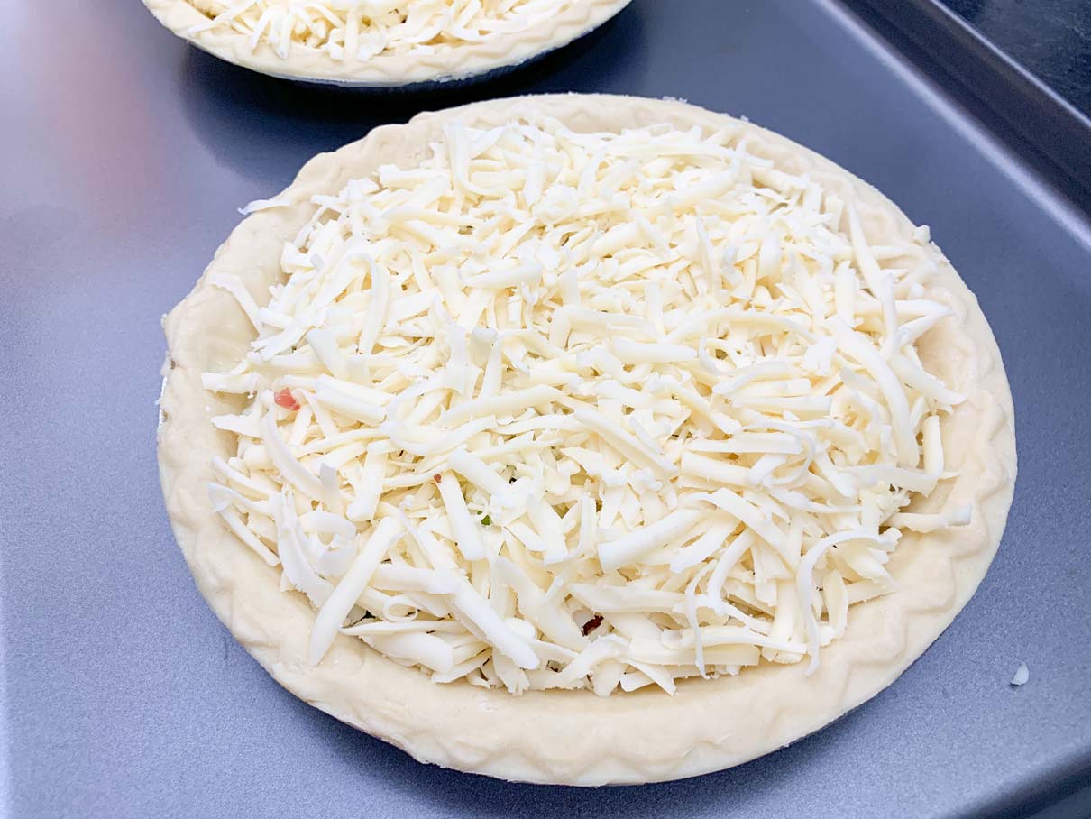 pie shell heaped with grated cheese
