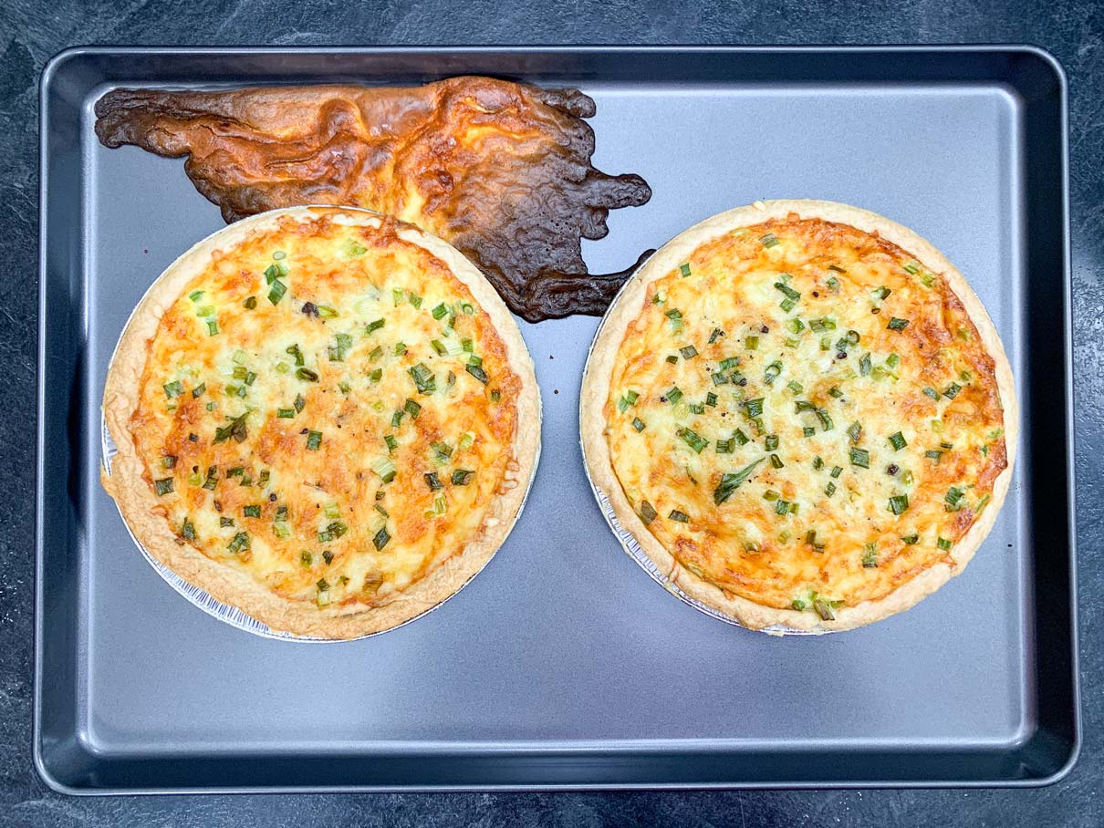 quiche, fresh from the oven, resting on baking sheet