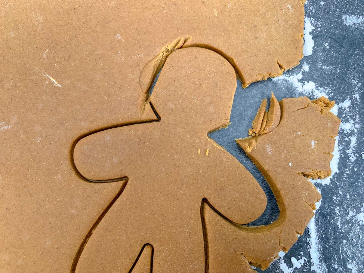 close up of a gingerbread man cut out of dough