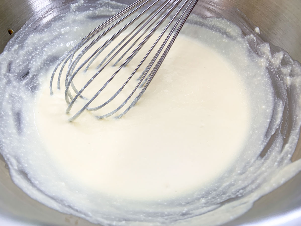 whisking together eggs, ricotta and vanilla in bowl