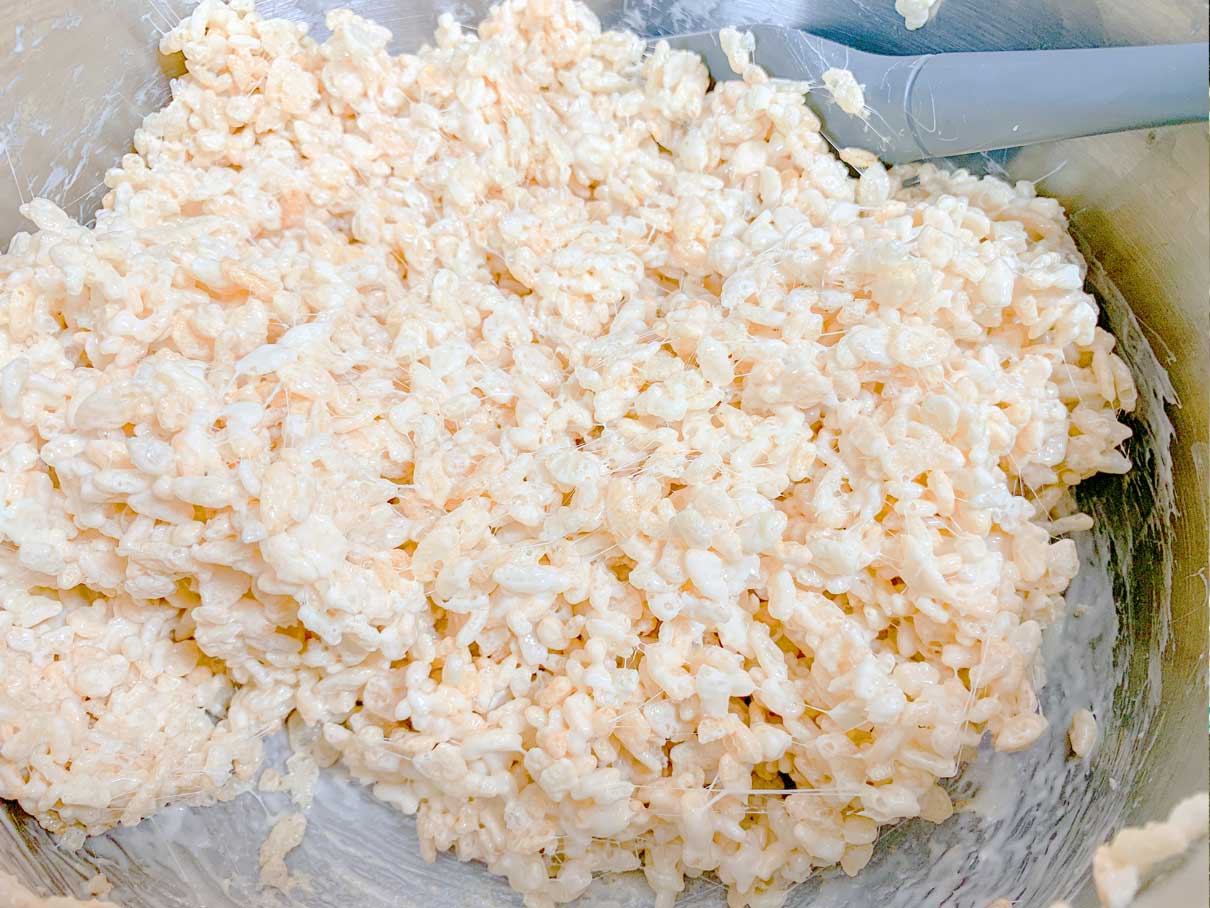 rice krispies and marshmallows mixed together in a sauacepan