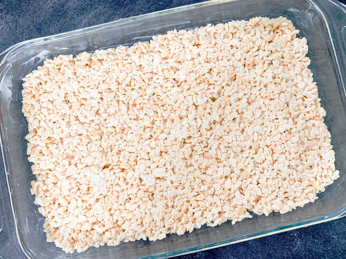 rice krispies smoothed evenly into a 9x13 baking dish