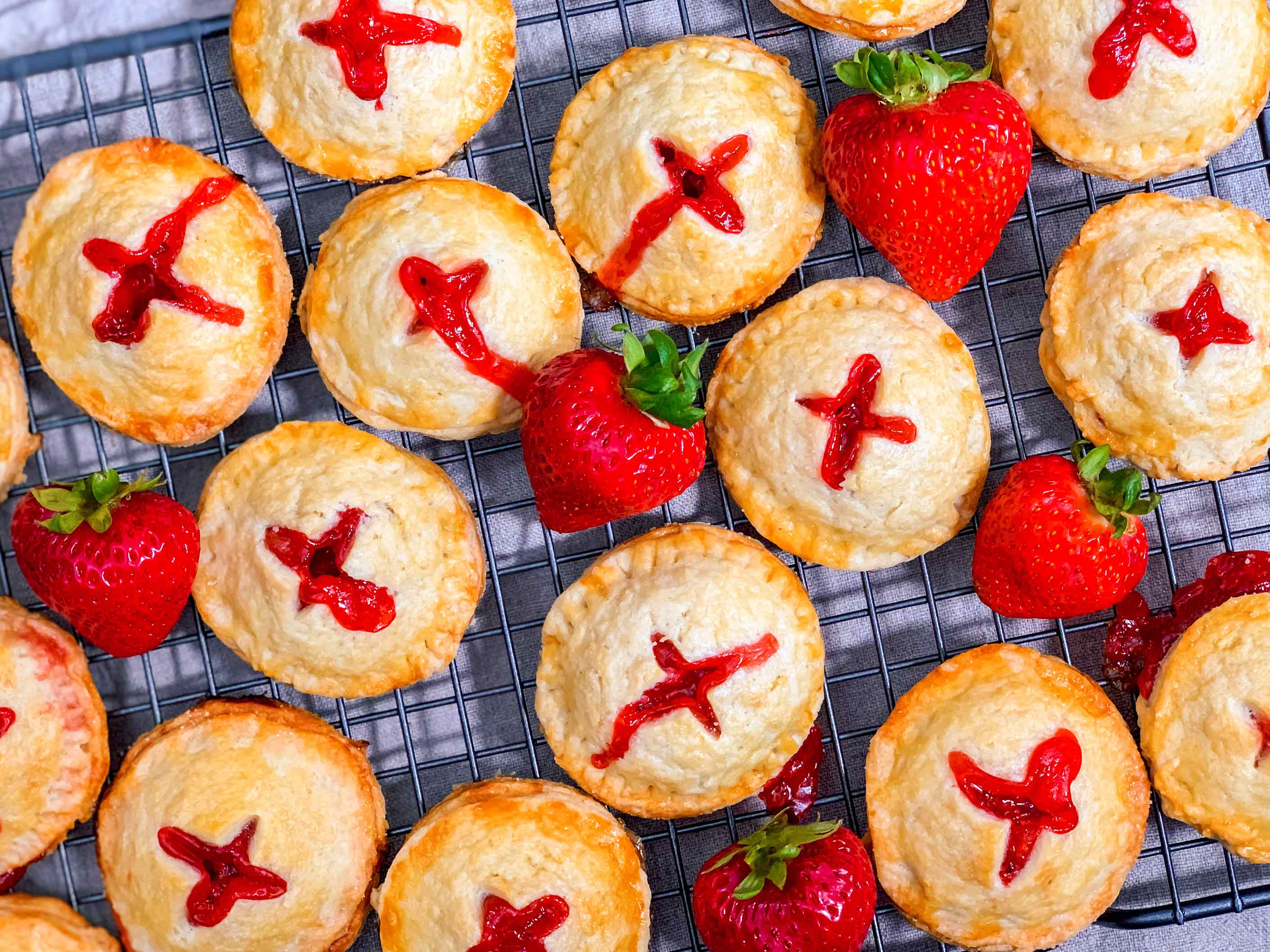 strawberry rhubarb hand pies on a wire cooling rack