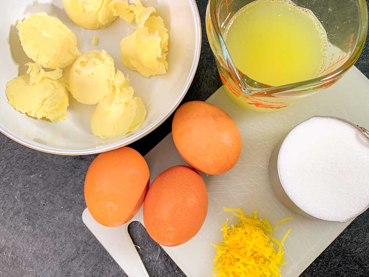 lemon curd ingredients on counter (butter, lemon juice, zest, eggs and sugar)