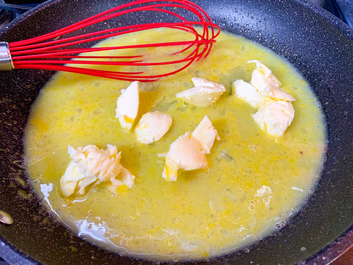 eggs, lemon juice, zest and sugar whisked together in a frying pan with nobs of butter mixed in