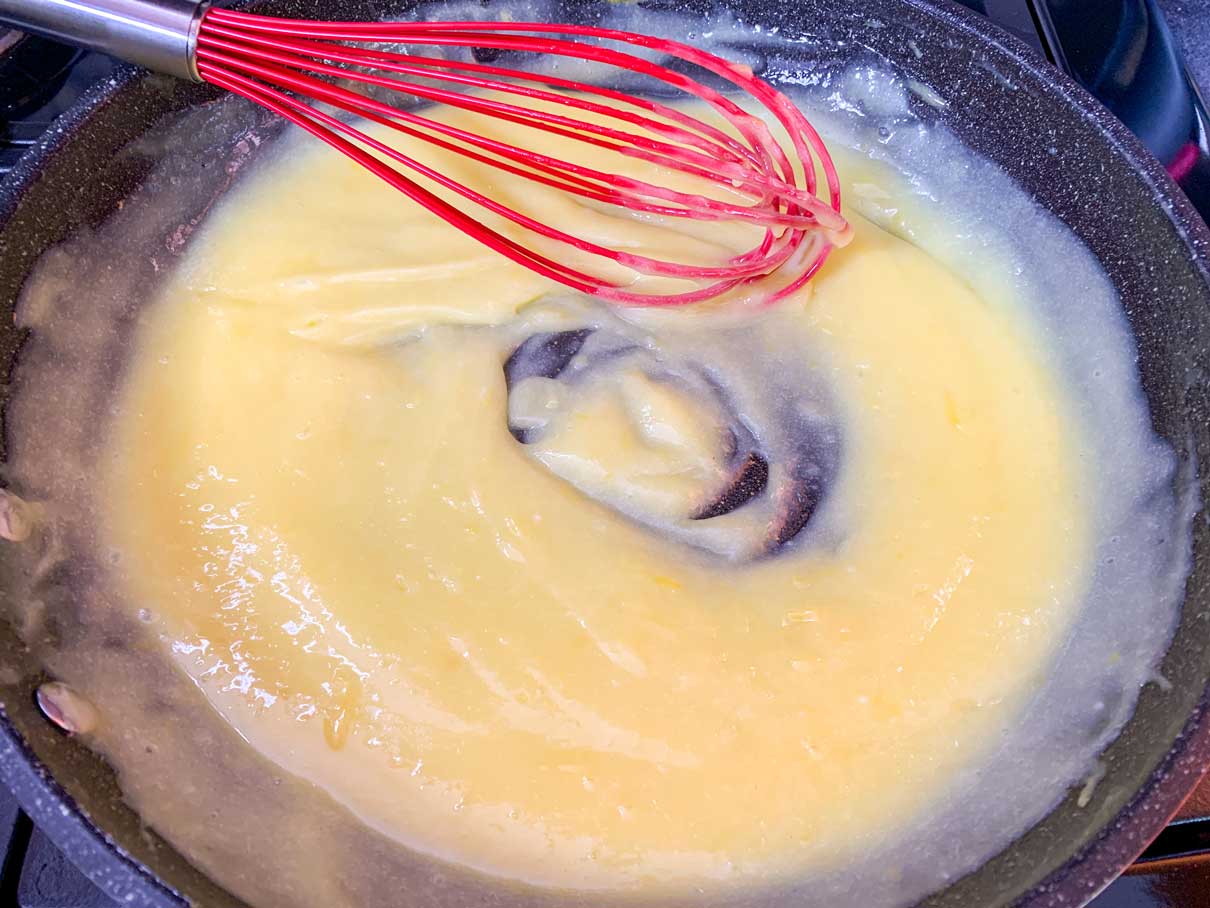 thickened lemon curd in a frying pan