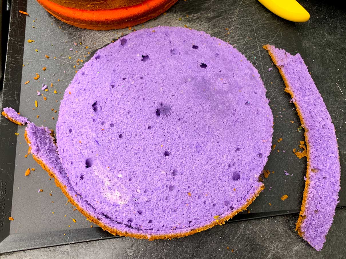 trimming the outer edge off of the purple cake