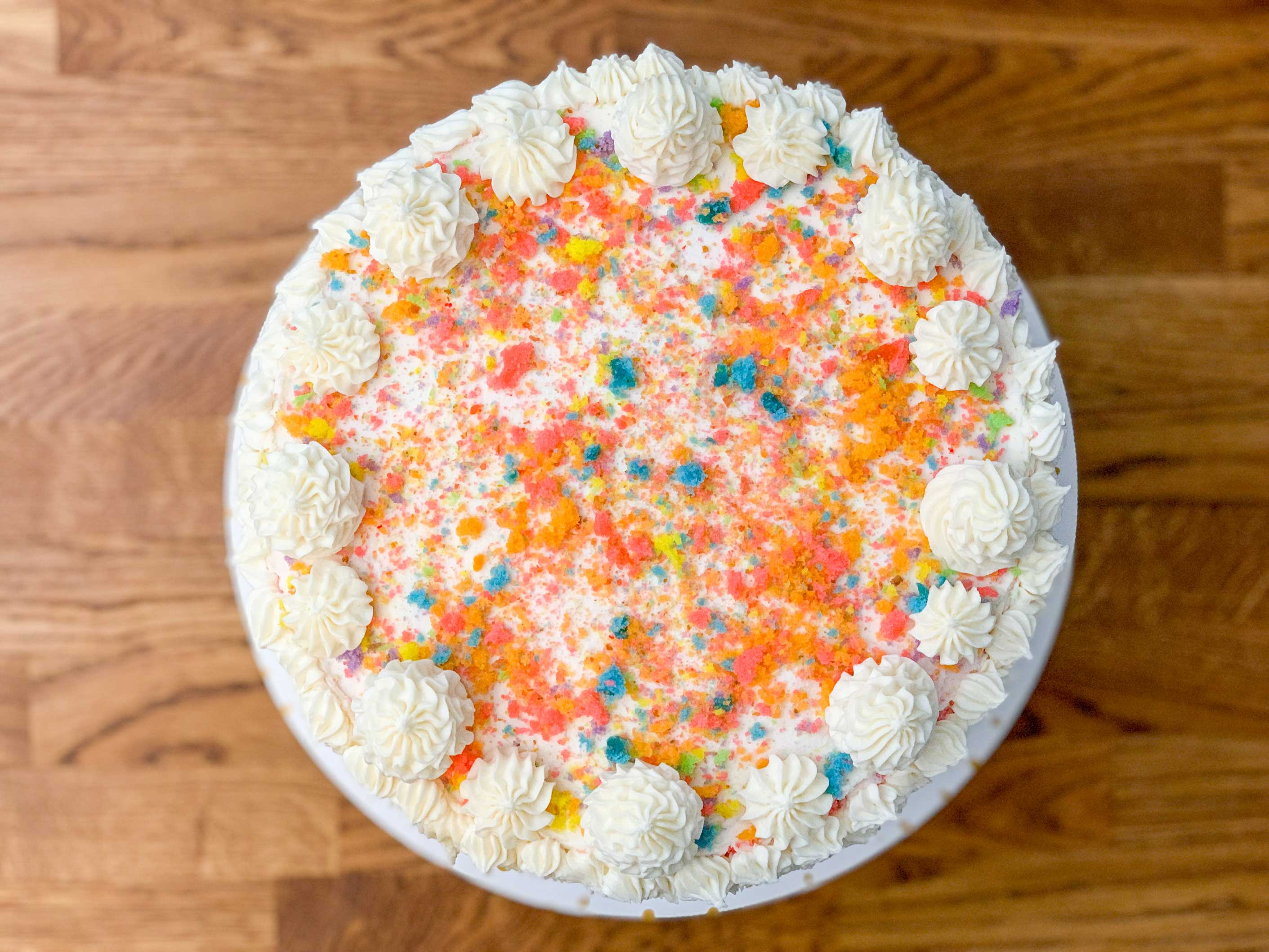 birds eye view of the finished cake with rainbow cake crumbs sprinkled on top